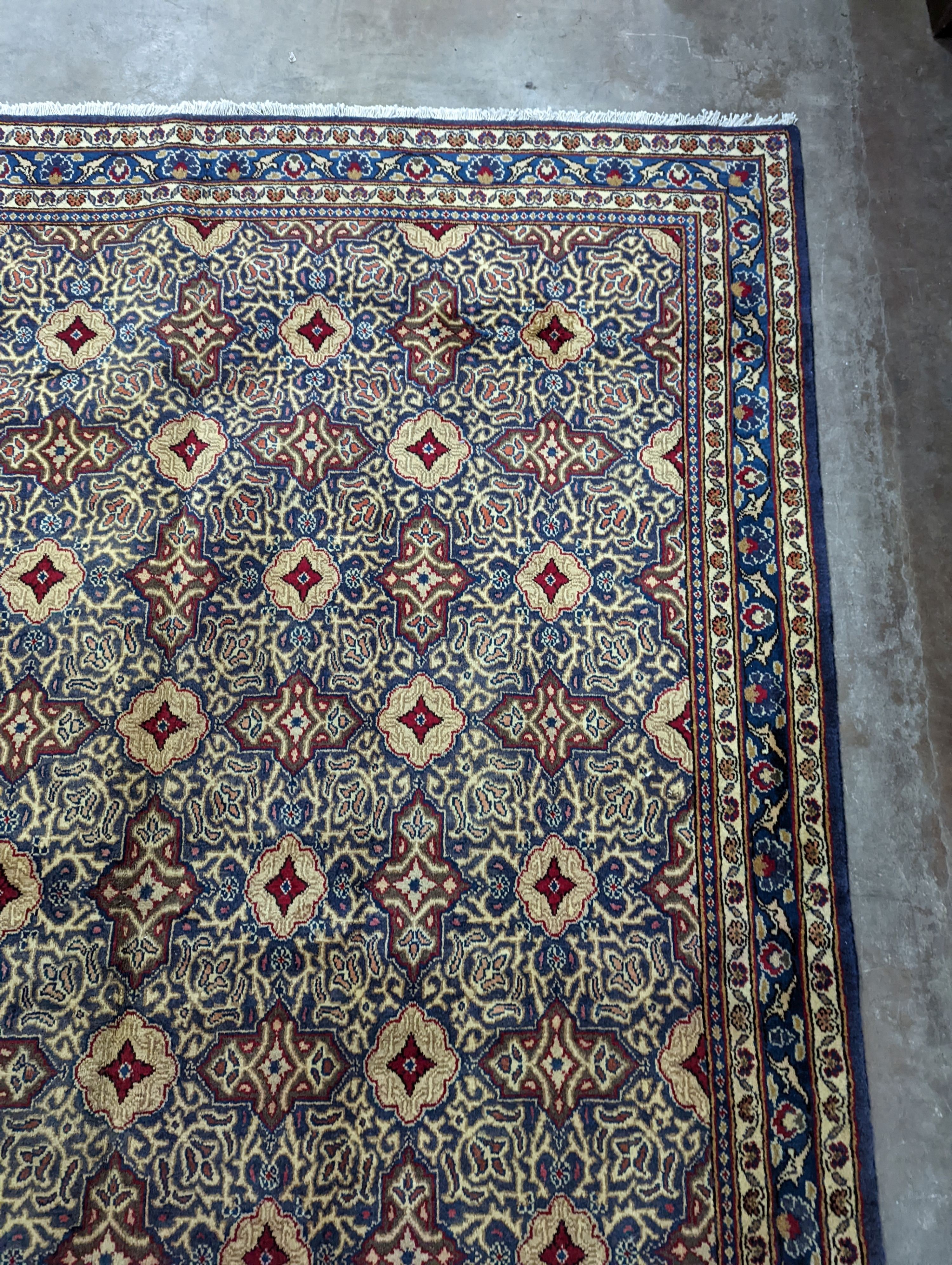 A meshed blue ground carpet, 290 x 190cm